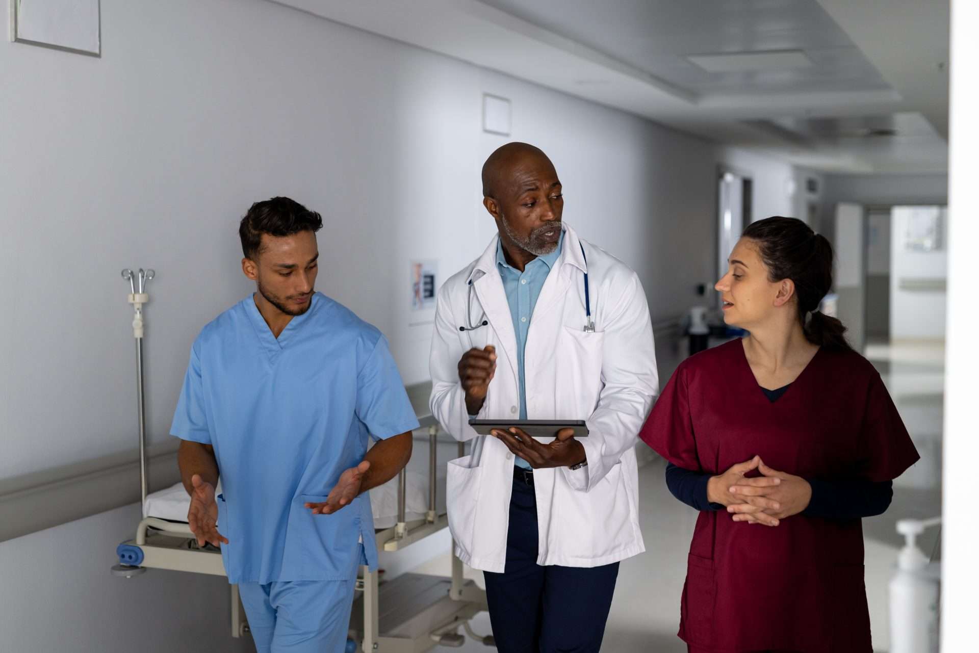 International medical graduates walking and talking within hospital.