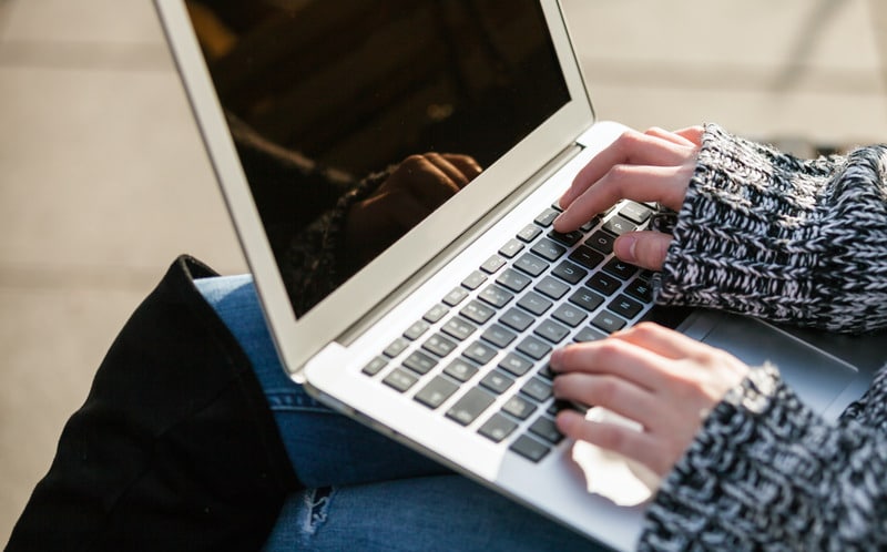 Person typing on a laptop.
